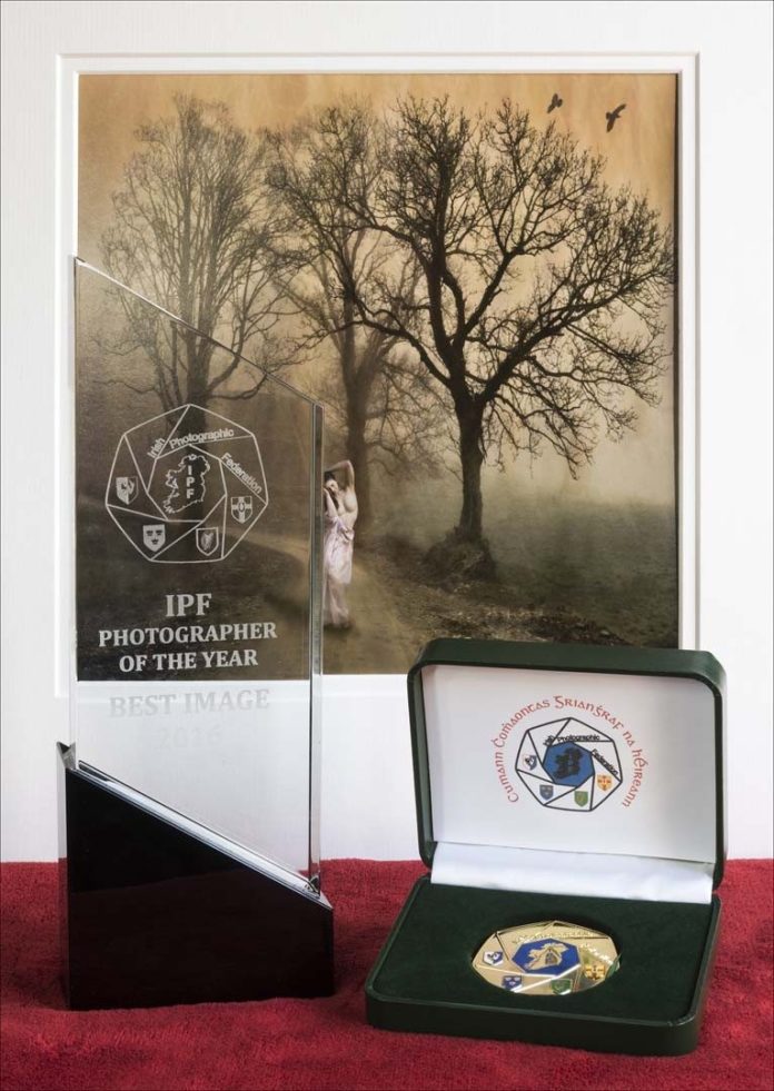 Bill's Photographer of the Year award with the winning image in the background.