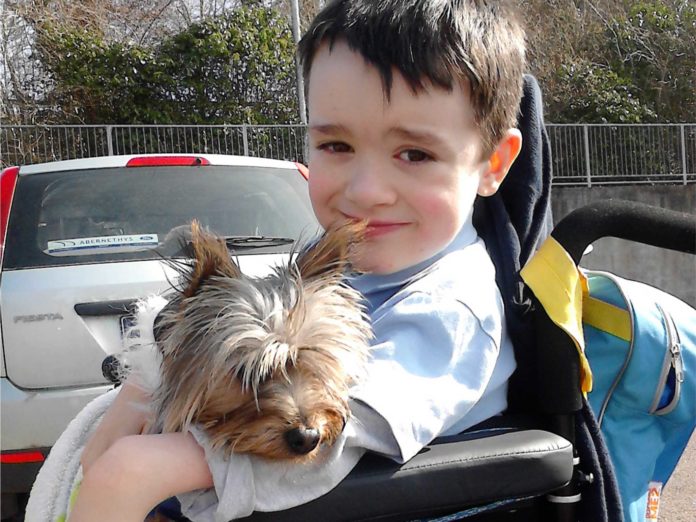 A happy looking 9 year old Josh Duffy with his dog.