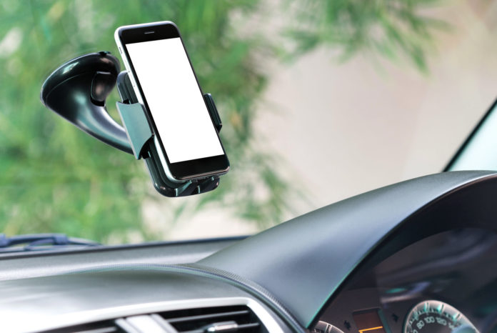 58033808 - close up phone mounted in car