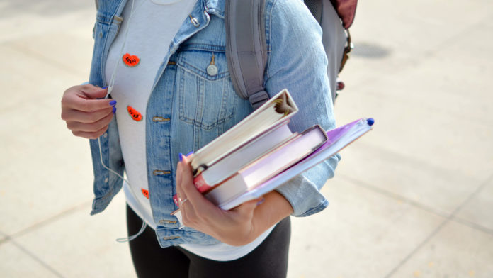Student with books web stock@28-08-2019-18:33:26.jpg