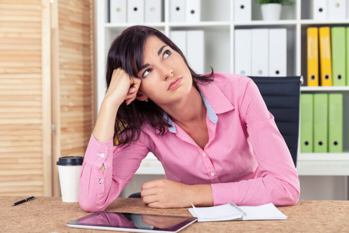 Bored secretary in pink shirt