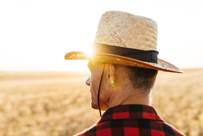 Image of masculine adult man looking aside while standing at cer