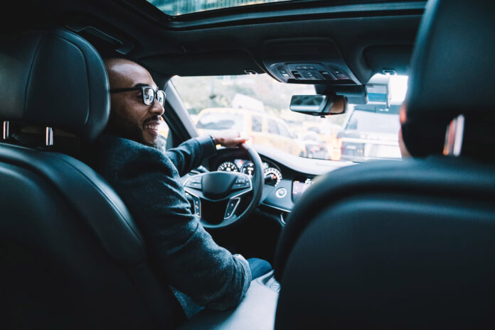 cheerful-executive-black-businessman-driving-car-2024-05-28-17-45-19-utc-scaled