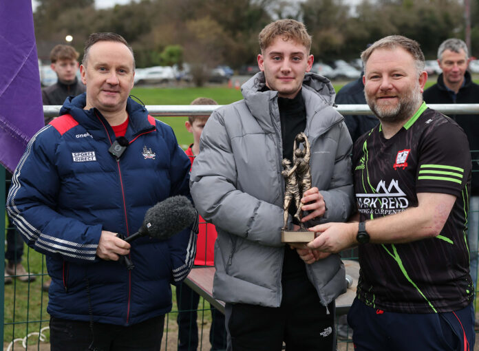 Jayden Daly, son of the late Barry Daly, accepts the winning tro